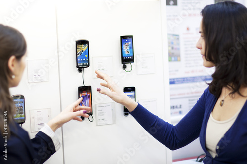 Photo: Woman choosing a phone Woman choosing a phone