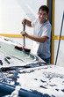Young man washing his car with compression water