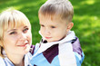 Young mother with her son in summer park Young mother with her son in summer park