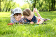 Foto: Children in the park reading a book Children in the park reading a book
