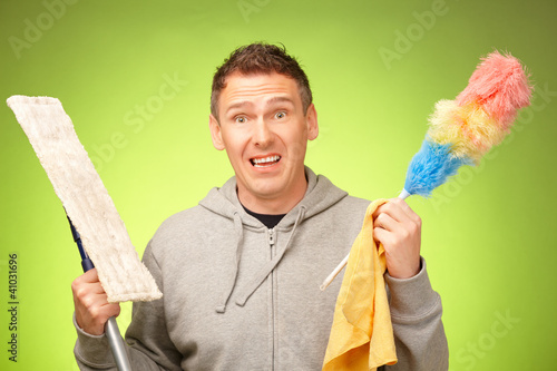 Photo: Man unhappy to clean the house Man unhappy to clean the house