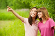 Two young pretty girls in a park