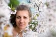 Young woman with spring flowers of sakura Young woman with spring flowers of sakura