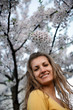 Young woman with spring flowers of sakura Young woman with spring flowers of sakura