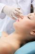 A young woman receiving an injection, closeup