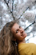 Young woman with spring flowers of sakura Young woman with spring flowers of sakura