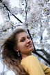 Young woman with spring flowers of sakura Young woman with spring flowers of sakura