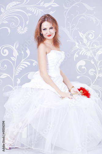 Photo: A young woman in a white wedding dress A young woman in a white wedding dress