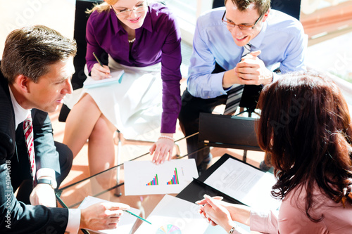 Photo: Business people having meeting in office Business people having meeting in office