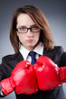 Young businesswoman in boxing concept