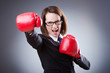 Young businesswoman in boxing concept