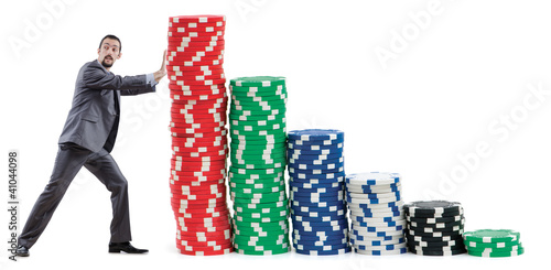 Photo: Businessman and casino chips on white Businessman and casino chips on white