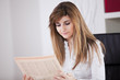 Businesswoman reading the newspaper Businesswoman reading the newspaper