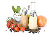 bottle of olive oil and spices and vegetables isolated on white