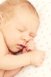Adorable tightly sleeping newborn baby girl
