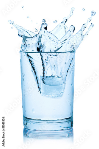 Photo: Splash from ice cube in a glass of water. Splash from ice cube in a glass of water.