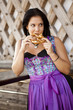German girl wearing typical bavarian clothes holding breze