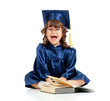Emotional funny child in academician clothes  with book