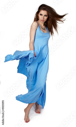 Photo: young woman in blue dress posing in studio young woman in blue dress posing in studio