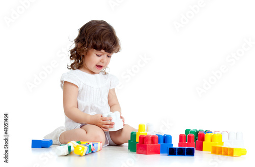 Photo: little child with construction set over white background little child with construction set over white background