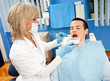 woman dentist with male patient