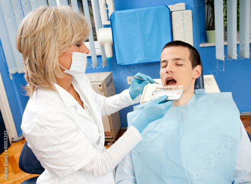 Photo: woman dentist with male patient woman dentist with male patient