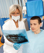 Photo: woman dentist with male patient woman dentist with male patient