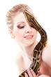 Photo: Beautiful woman holding python on isolated white Beautiful woman holding python on isolated white