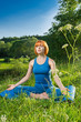 Red woman practicing fitness yoga outdoors