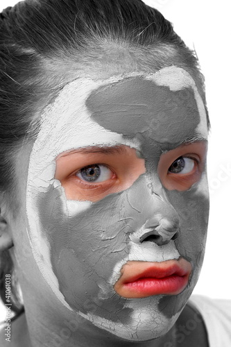 Photo: Sad teenager with grey cosmetic mask Sad teenager with grey cosmetic mask