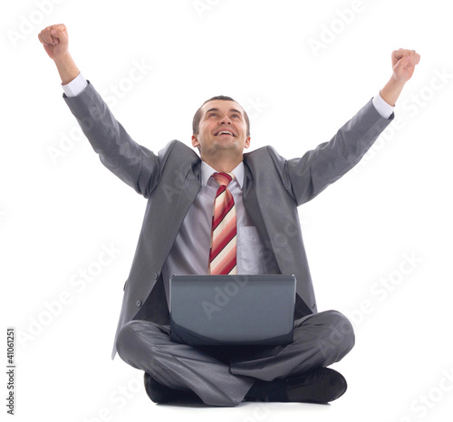 Photo: Business man celebrating his success with a computer laptop Business man celebrating his success with a computer laptop