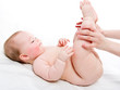 Mother massaging her baby girl