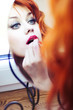 Photo: Beautiful redhead puts make up on. Beautiful redhead puts make up on.