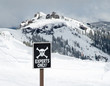 Sign with skull and bones designating experts only skiing area