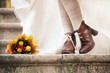 colorful autumn bouquet and two women legs with leather boots colorful autumn bouquet and two women legs with leather boots