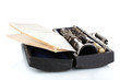 Antique clarinet in case and notebook with notes isolated Antique clarinet in case and notebook with notes isolated
