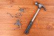 Hammer and metal nails on wooden background Hammer and metal nails on wooden background