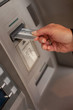 Foto: Female hand inserting ATM card Female hand inserting ATM card