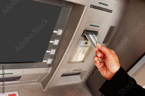 Photo: Woman using an ATM Woman using an ATM