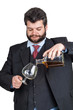 Businessman pouring a glass of whisky Businessman pouring a glass of whisky
