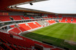 View on an empty football (soccer) stadium with red seats View on an empty football (soccer) stadium with red seats