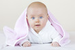 cute baby girl on bed learning how to crawl.