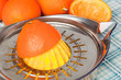 Extracting juice from oranges with a citrus juicer