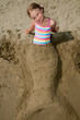 Summer fun - lovely mermaid, girl playing on sandy beach