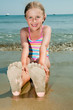 Summer fun - lovely girl playing on sandy beach