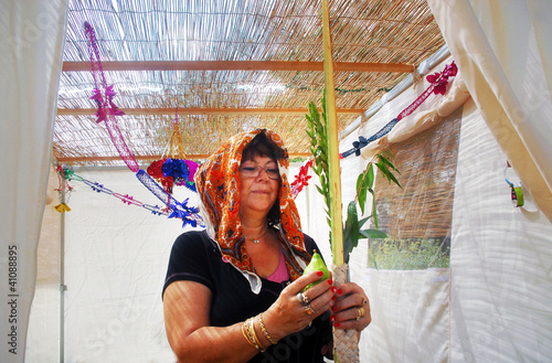 Photo: Praying in Sukkah for Jewish Holiday Sukkot Praying in Sukkah for Jewish Holiday Sukkot