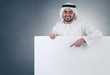 arabian business man pointing at a blank white sign
