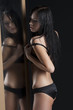 sexy woman next to a wet mirror