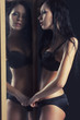 sexy lady in underwear to the mirror