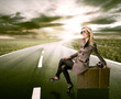 Beautiful blond woman waiting on road, concept of travel